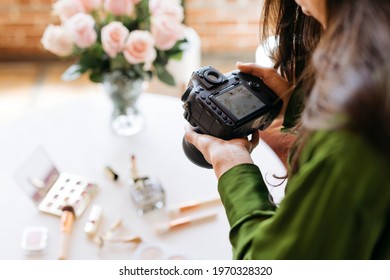 Female photographer shooting beauty products on the table - Shutterstock ID 1970328320