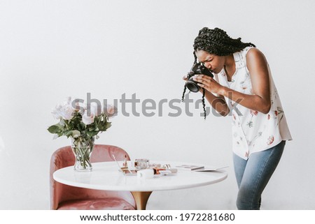 Female photographer shooting beauty products on the table