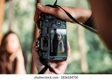 Female Photographer Takes Portrait Photos Of A Girl. Close Up On Camera Screen