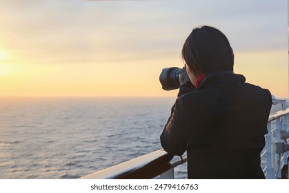 Female photographer taking photos on a cruise ship at sunset. Alaska. Alaska. 