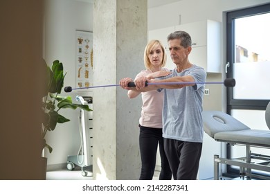 Female Physical Therapist Working With Senior Man About His Balance