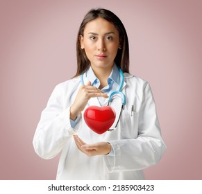 Female Physician Or Nurse Covering With Hands A 3d Rendered Image Of Heart. Cardiovascular Disease In Women. Risk Factors And Symptoms, Prevention And Treatment Concept.