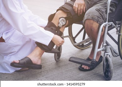 Female Physiotherapist Fixing Knee Braces On Man's Leg In out door, image of doctor putting on knee brace to asian patient, Health concept.selective focus - Powered by Shutterstock