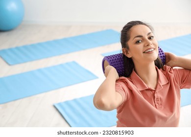 Female physiotherapist with foam roller in rehabilitation center - Powered by Shutterstock