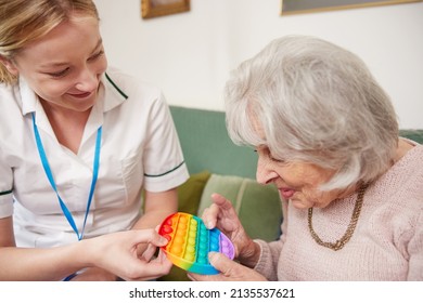 Female Physiotherapist Getting Senior Woman To Use Fidget Toy - Shutterstock ID 2135537621