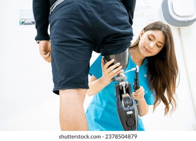 Female physiotherapist helping young man with prosthetic leg.
Nurse helping man walk with prosthetic leg.
Young disabled man using orthopedic equipment to walk - Powered by Shutterstock