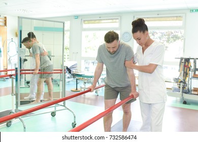 Female Physiotherapist Teaching Patient How To Walk