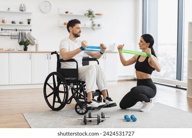 Female physiotherapist or wife showing mature male patient in wheelchair how to exercise with stretching bands at home. Rehab fitness for senior patients concept. - Powered by Shutterstock