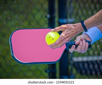 Female pickleball player about to hit a sever to start the game - Shutterstock ID 2194031521