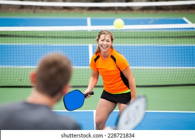 Female Pickleball Player On The Court. 