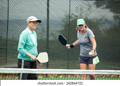 Female Pickleball Players On An Outdoor Court