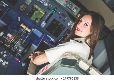 Female Pilot In The Airplane Cockpit