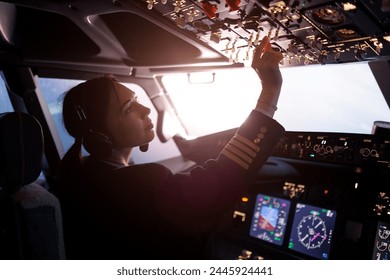 A female pilot controls a large passenger plane - Powered by Shutterstock