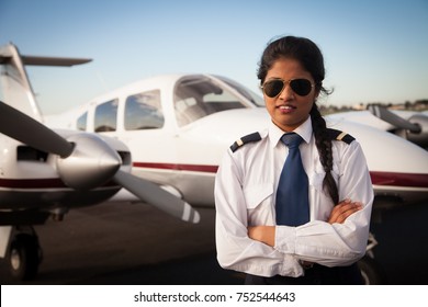 Female Pilot Standing in Front of Aircraft
