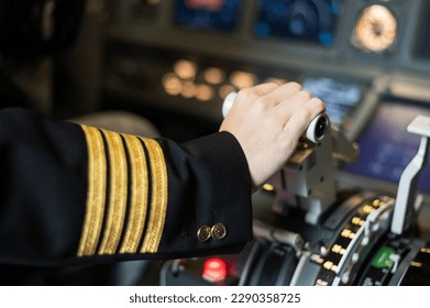 Female pilot's hand on the plane engine control stick. - Powered by Shutterstock