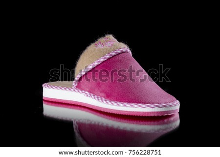 Female Pink Slipper on Black Background, isolated product, comfortable footwear.