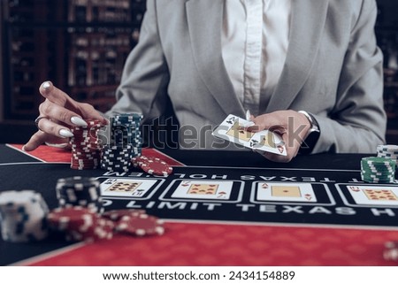 female player shows winning combination of two aces, win in casino poker. Gambling concept