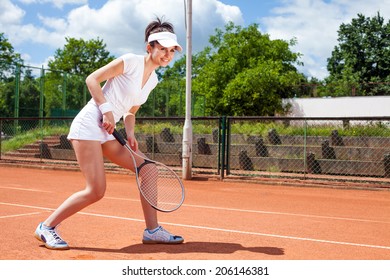 Female playing tennis on court - Shutterstock ID 206146381
