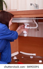 Female Plumber Repairing Sink