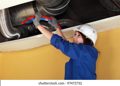 Female Plumber At Work.