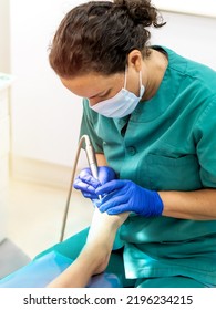 Female Podiatrist Doing Chiropody In Her Podiatry Clinic. Selective Focus