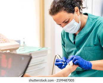 Female Podiatrist Doing Chiropody In Her Podiatry Clinic. Selective Focus