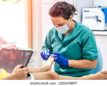 Female Podiatrist Doing Chiropody In Her Podiatry Clinic. Selective Focus