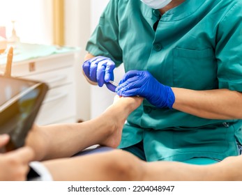 Female Podiatrist Doing Chiropody In Her Podiatry Clinic. Selective Focus