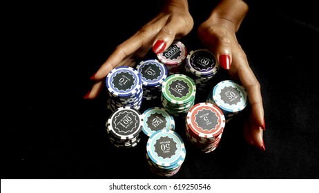 The Female Poker Player With Paint Red Nails, Pushing Her Poker Chips Going All In Forward To Bet On Black Fabric,  Gambling And Casino Business Concept