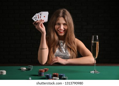 Female Poker Player At Table In Casino