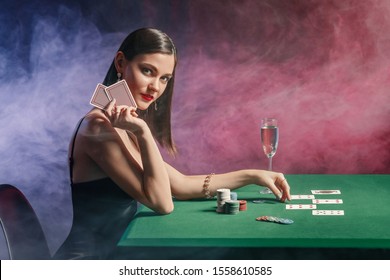 Female Poker Player At Table In Casino