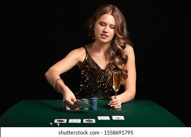 Female Poker Player At Table In Casino