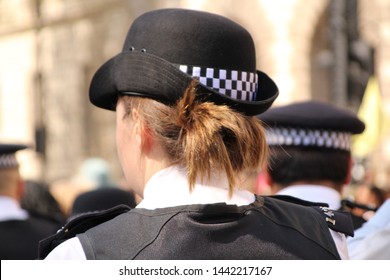 Female Police Officer On The Beat, Walking In London, England