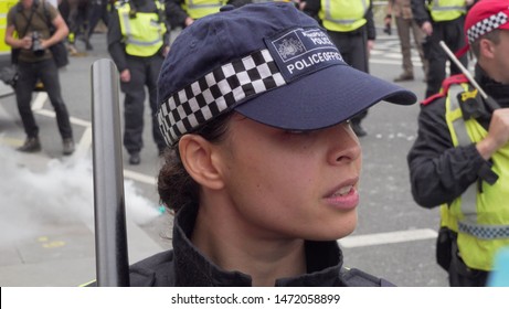 A female police officer stands on duty during the Tommy Robinson protest outside the BBC studio in London, UK, 03/08/19