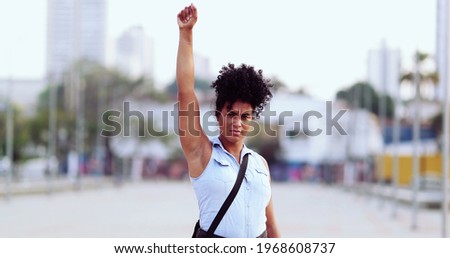 Female political activist raising fist in the air
