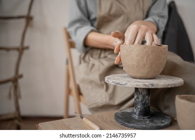 female potter creates handmade handicrafts. Close-up of hands sculpting a clay bowl on a working table in a ceramics studio in a workshop. artistic concept. copy space. - Powered by Shutterstock