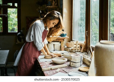 Female potter sculpts from clay at her workshop. raw clay shaping process close up. Mastering the art of pottery craft ceramics - Powered by Shutterstock