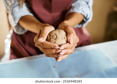 Female potter sculpts from clay at her workshop. raw clay shaping process close-up, top view. Mastering the art of pottery craft ceramics - Powered by Shutterstock