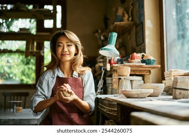 Female potter sculpts from clay at her workshop. raw clay shaping process close up. Mastering the art of pottery craft ceramics - Powered by Shutterstock