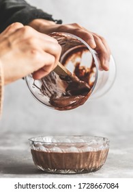 Female Pouring Chocolate Cake Batter Into Small Glass Bowl