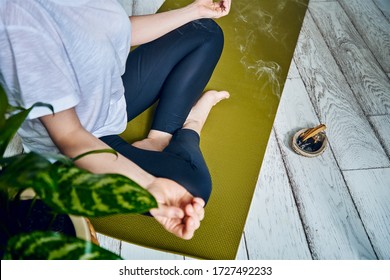 Female Practicing Yoga In Quarantine At Home. National Yoga Day. Healthy Living In Lockdown. Using For Meditation Palo Santo Sticks.