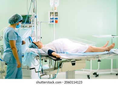 Female pregnant patient during cesarean section. The process. preparing to operation in labor room. Woman lying on operating table.