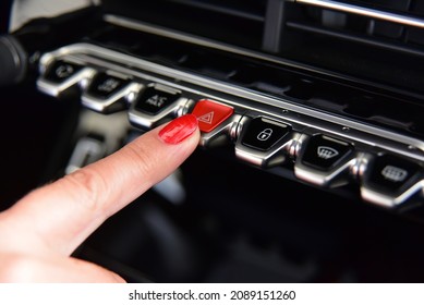 Female Pressing Red Triangle Car Hazard Warning Button