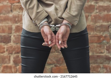 A Female Prisoner, The Prisoner's Hands Are Handcuffed Behind Her Back. Close-up.