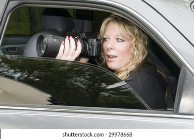 Female Private Investigator Or Spy Or Secret Agent Taking Photographs From Car