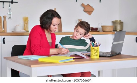 Female private tutor helping young student with homework at desk in bright child's room. mother helps son to do lessons. home schooling, home lessons. - Powered by Shutterstock