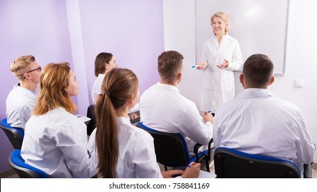 Female Professor Giving Presentation For Medical Students In Lecture Hall 