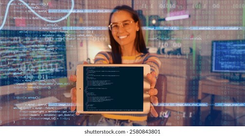 Female programmer with tablet computer in office at night