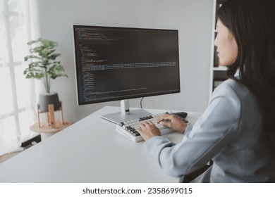 Female programmer typing on computer keyboard, programmer designing custom computer programming, coding programs and websites. Computer programming design concepts.