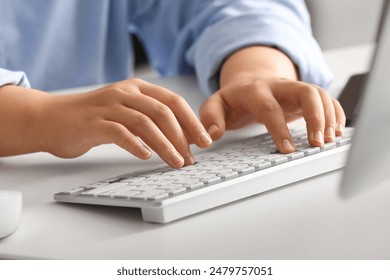 Female programmer typing on computer keyboard in office, closeup